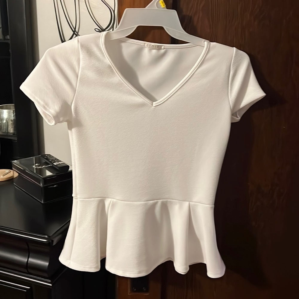 NWOT white peplum shirt. Size small. Smoke and animal free home.